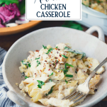 Side shot of a bowl of spinach artichoke chicken casserole with text title overlay