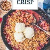 Skillet of strawberry crisp with text title overlay