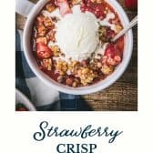 Bowl of strawberry crisp with text title at the bottom