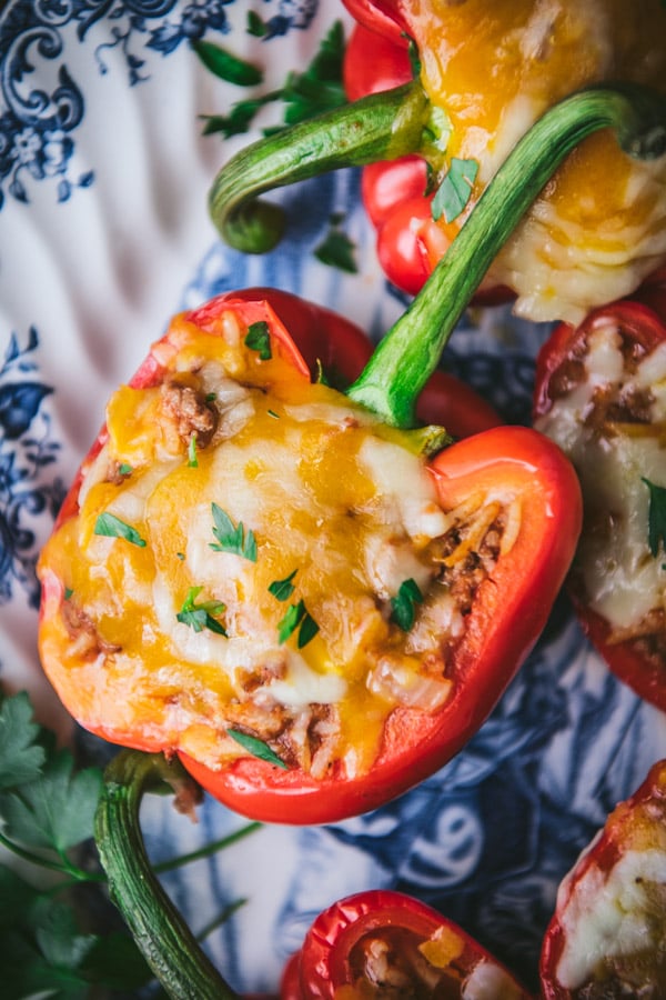 Close overhead image of stuffed peppers with rice and melted cheese