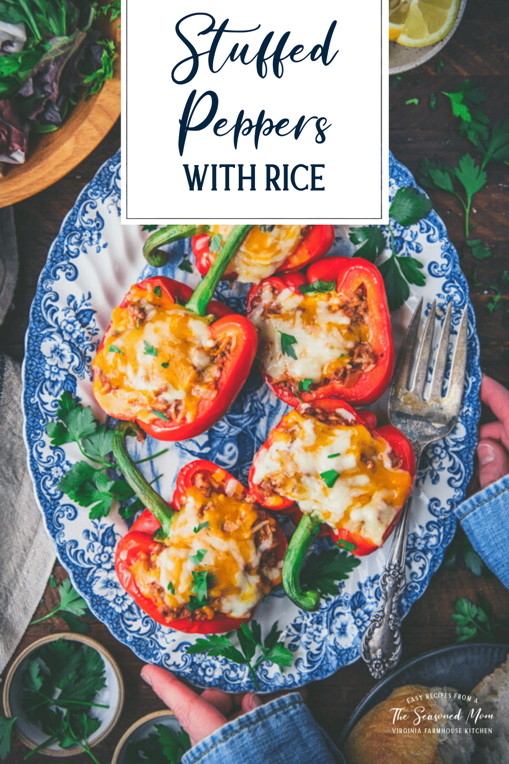 Overhead shot of hands holding a platter of stuffed peppers with rice and text title overlay