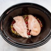 Chicken breasts in a slow cooker.