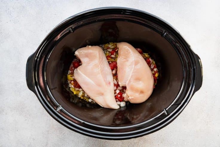 Chicken breasts in a slow cooker.