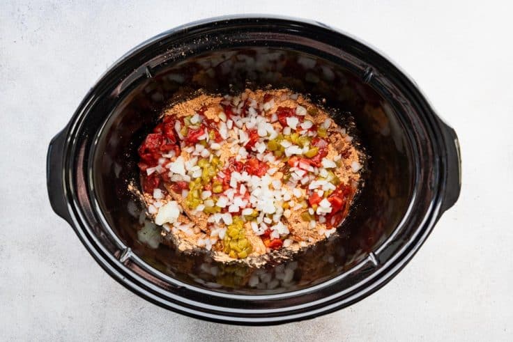 Process shot showing how to make Mexican chicken in the slow cooker.