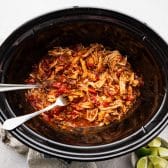 Process shot showing how to shred crockpot Mexican chicken.