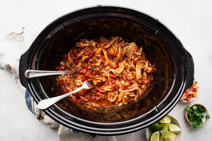 Process shot showing how to shred crockpot Mexican chicken.