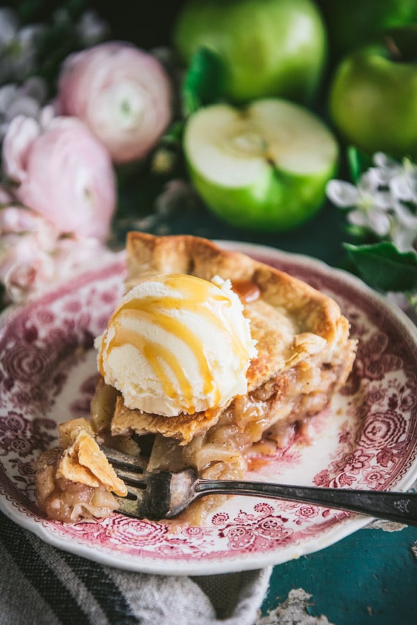Close up shot of a bite of apple pie on a fork