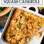 Close overhead image of a spoon in a dish of squash casserole with text title box at top