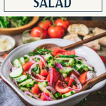 Side shot of a bowl of cucumber tomato onion salad with text title box at top