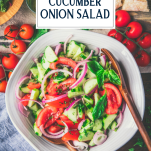 Close overhead image of tomato cucumber onion salad with text title overlay