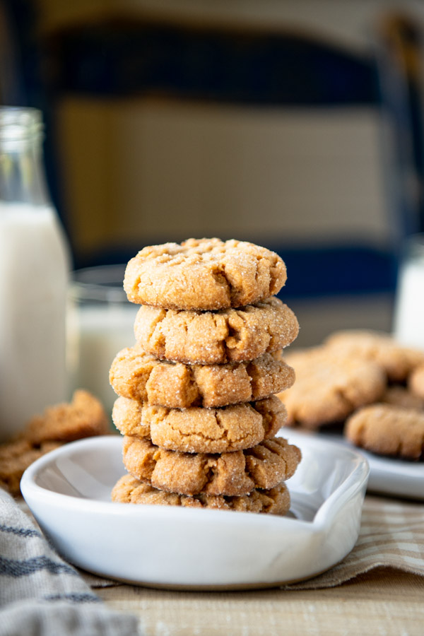 Stack of homemade peanut butter cookies in a white heart shaped dish