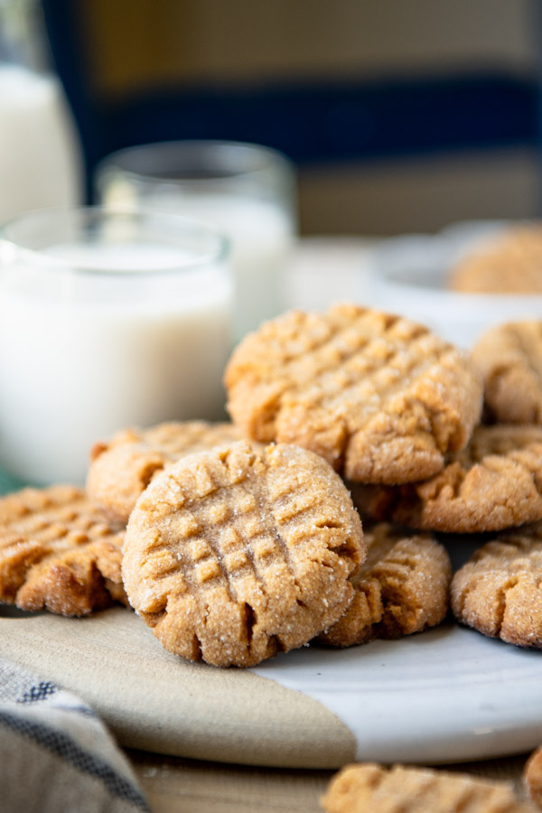Close up side shot of easy peanut butter cookies served with a glass of milk