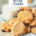 Close up side shot of a pile of easy peanut butter cookies with milk and text title overlay