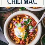 Close overhead shot of a bowl of chili mac with text title box at top