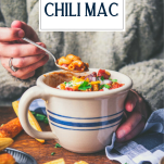 Person in sweater eating a bowl of chili mac with text title overlay