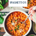 Overhead image of hands eating a bowl of homemade spaghetti o's with text title overlay