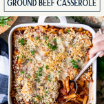 Hand serving Italian ground beef casserole from a dish with text title box at top