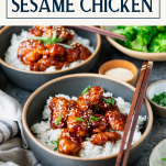 Side shot of two bowls of sesame chicken with text title box at top