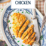 Close overhead image of a sour cream chicken breast recipe on a blue and white plate with text title overlay