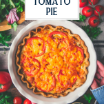 Overhead shot of hands holding a southern tomato pie with text title overlay