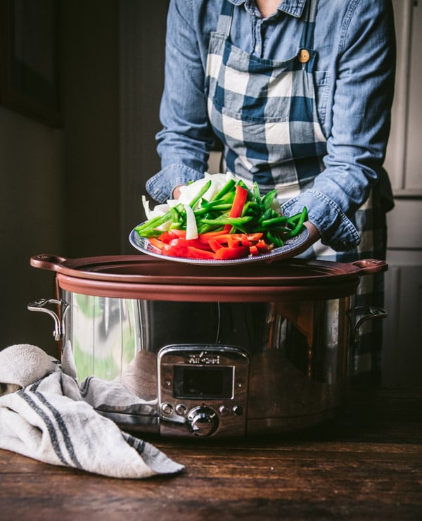 Adding bell peppers and onions to a slow cooker