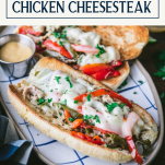 Plate of crock pot chicken philly cheesesteak with text title box at top