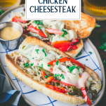 Plate of chicken philly cheesesteak with text title overlay