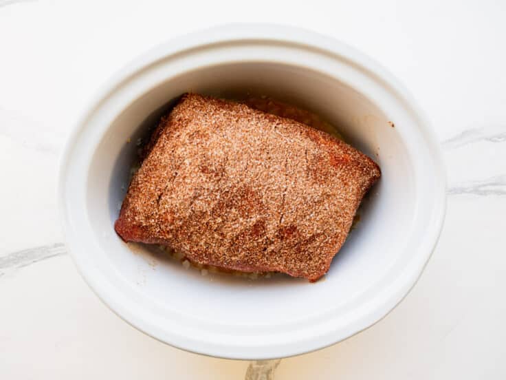Seasoned pork added to the slow cooker.