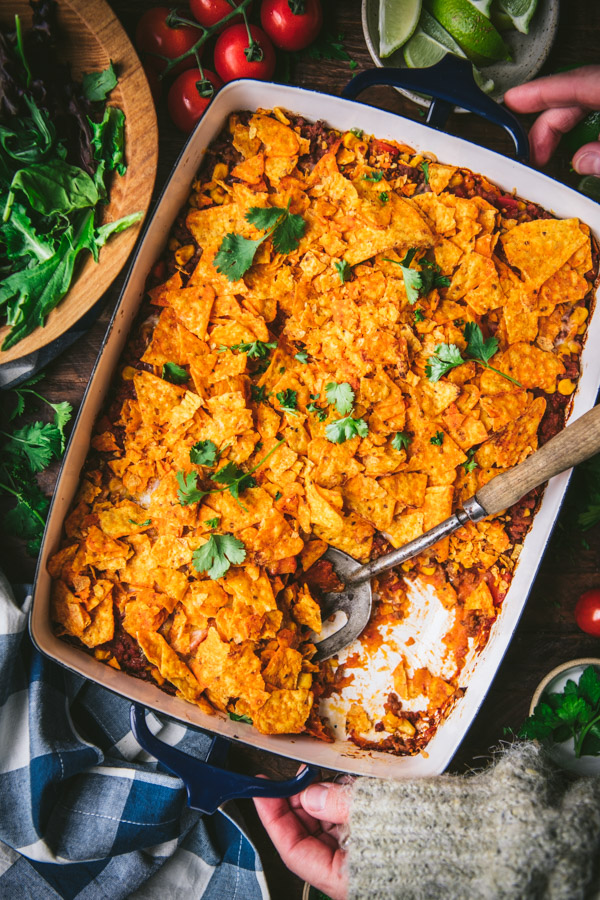 Overhead image of a pan of Dorito casserole at an angle on a wooden table