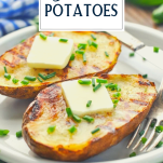 Plate of grilled baked potatoes with butter and chives and text title overlay