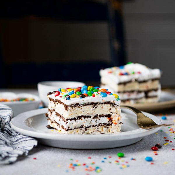 Square side shot of two slices of ice cream sandwich cake on white table
