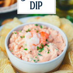 Close up shot of shrimp dip in a white bowl with text title overlay