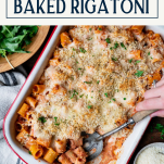 Hands serving a vegetarian baked rigatoni from a dish with text title box at top
