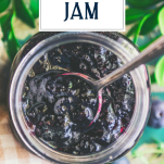 Close overhead image of a spoon in a jar of blueberry jam with text title overlay