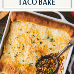 Close overhead shot of a pan of crescent roll taco bake with text title box at top