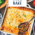 Overhead shot of a white dish of crescent roll taco bake with text title overlay