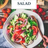 Bowl of tomato cucumber onion salad with text title overlay.