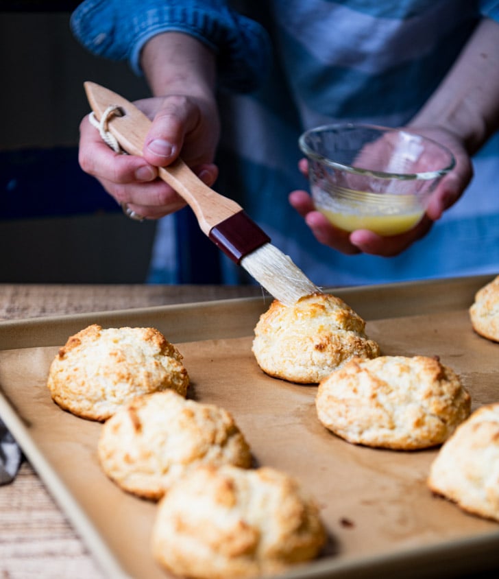 Brushing drop biscuits with melted butter