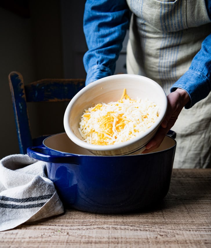 Adding grated cheese to a Dutch oven
