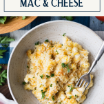 Close overhead shot of a bowl of the best homemade mac and cheese recipe with text title box at top