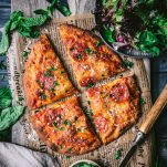 Square featured image of a sliced flatbread pizza on a cutting board