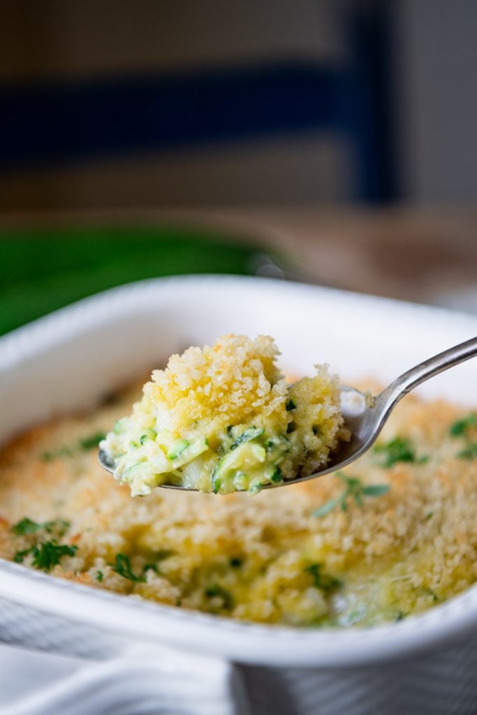 Close up shot of zucchini casserole on a serving spoon