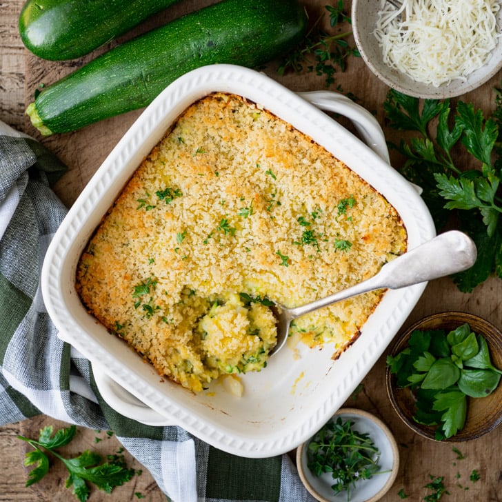 Square overhead shot of garlic parmesan zucchini casserole on a dinner table