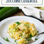 White plate with zucchini casserole and text title box at top