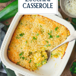 Overhead shot of a white pan of zucchini casserole with text title overlay