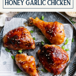 Close overhead shot of a plate of honey garlic chicken with text title box at top