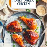 Overhead shot of baked honey garlic chicken on a plate with text title overlay
