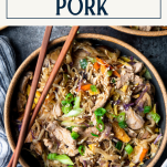 Close overhead shot of a bowl of moo shu pork with text title box at top
