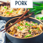 Side shot of two bowls of moo shu pork on a table with text title overlay