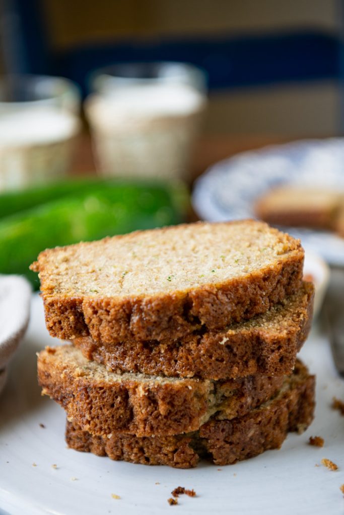 Close up side shot of a stack of the best zucchini bread recipe sliced on a white tray